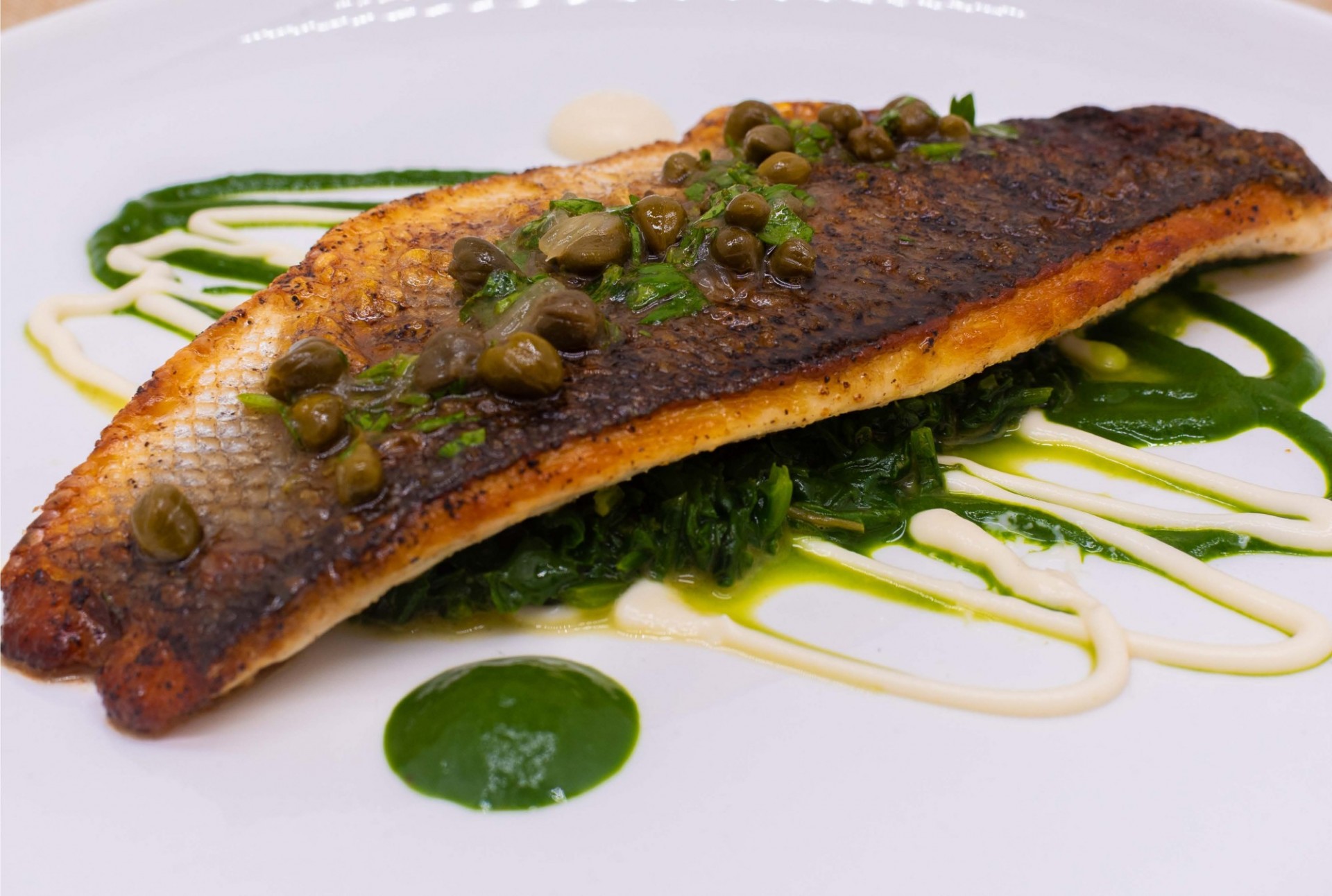 Pan seared trout on a bed of spinach