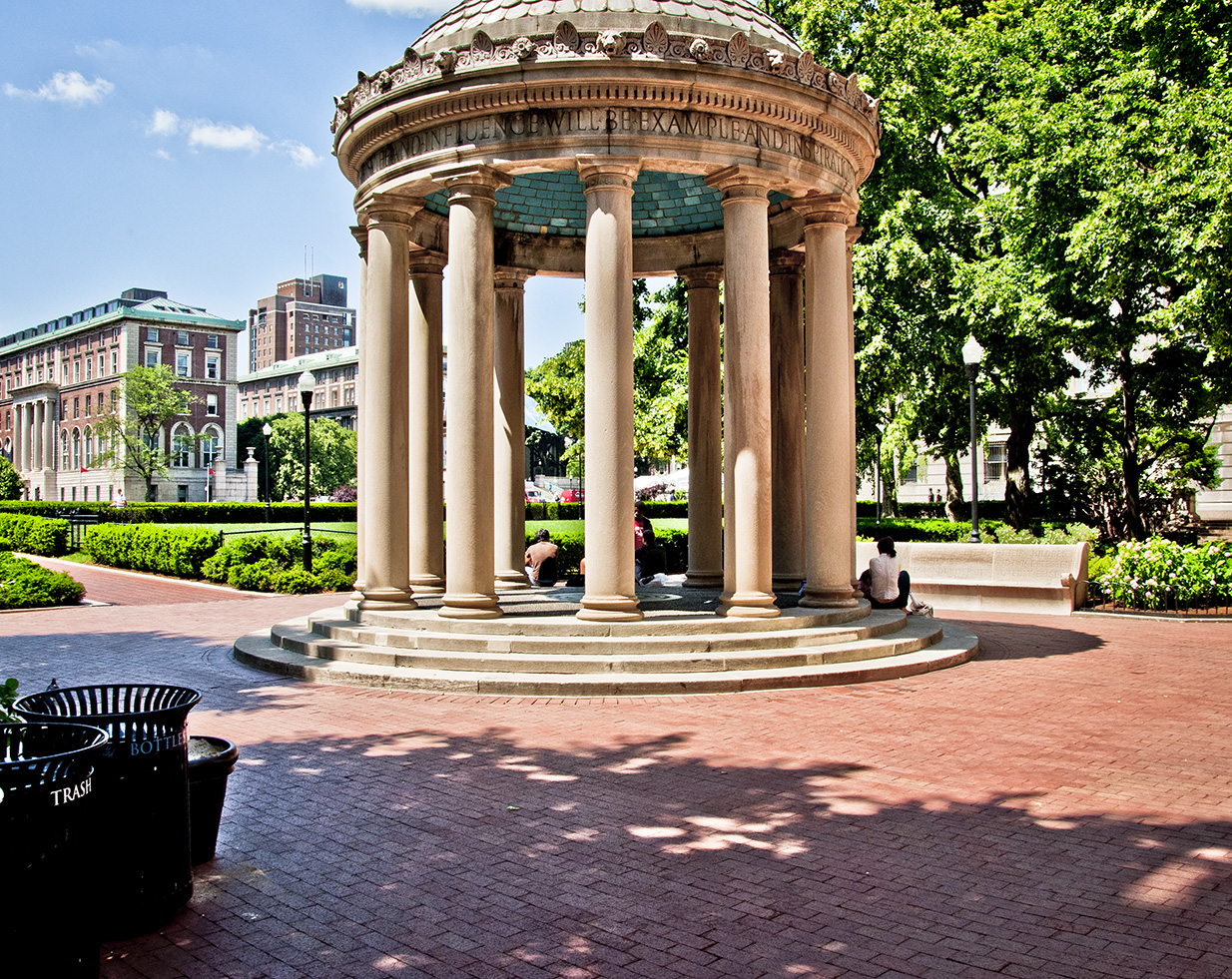 A stone gazebo is at the center of  brick plaza