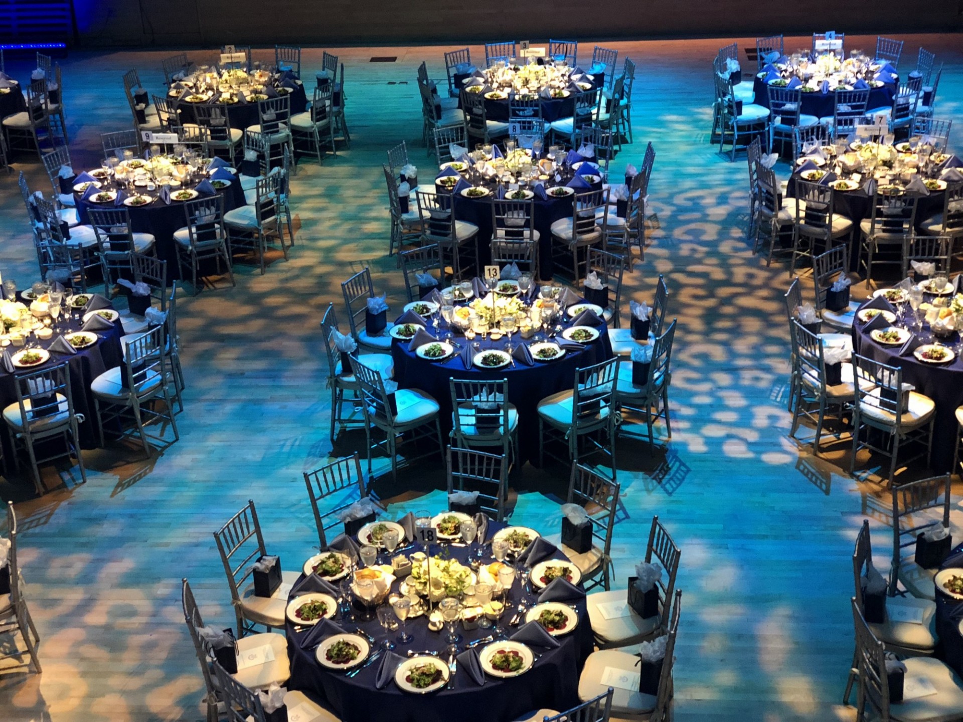 A room is set with banquet rounds