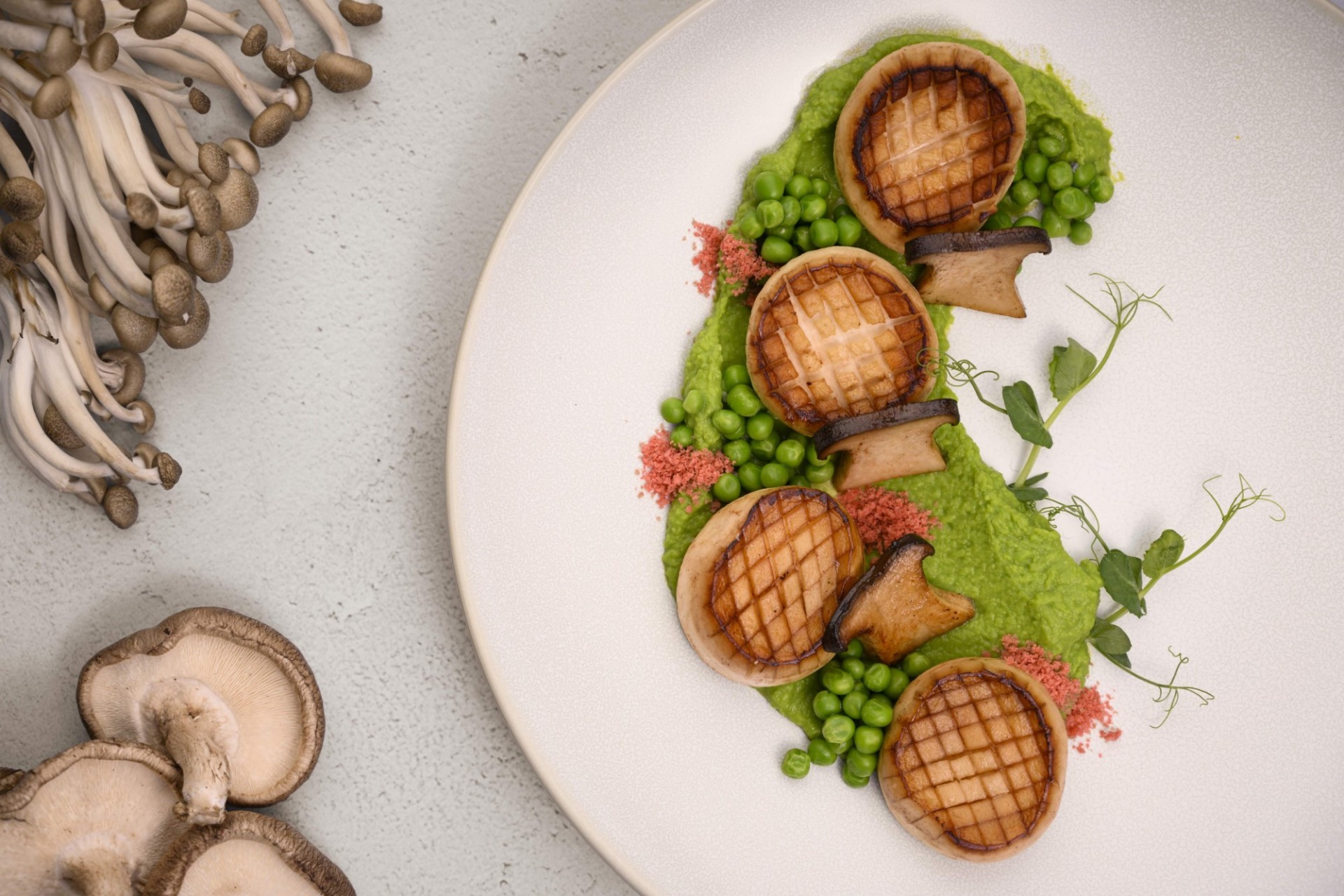 Pan seared scallops with pea puree and mushrooms
