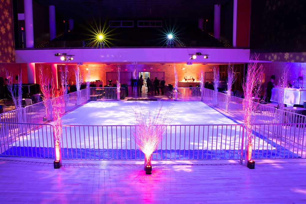 An indoor ice rink with a metal fence