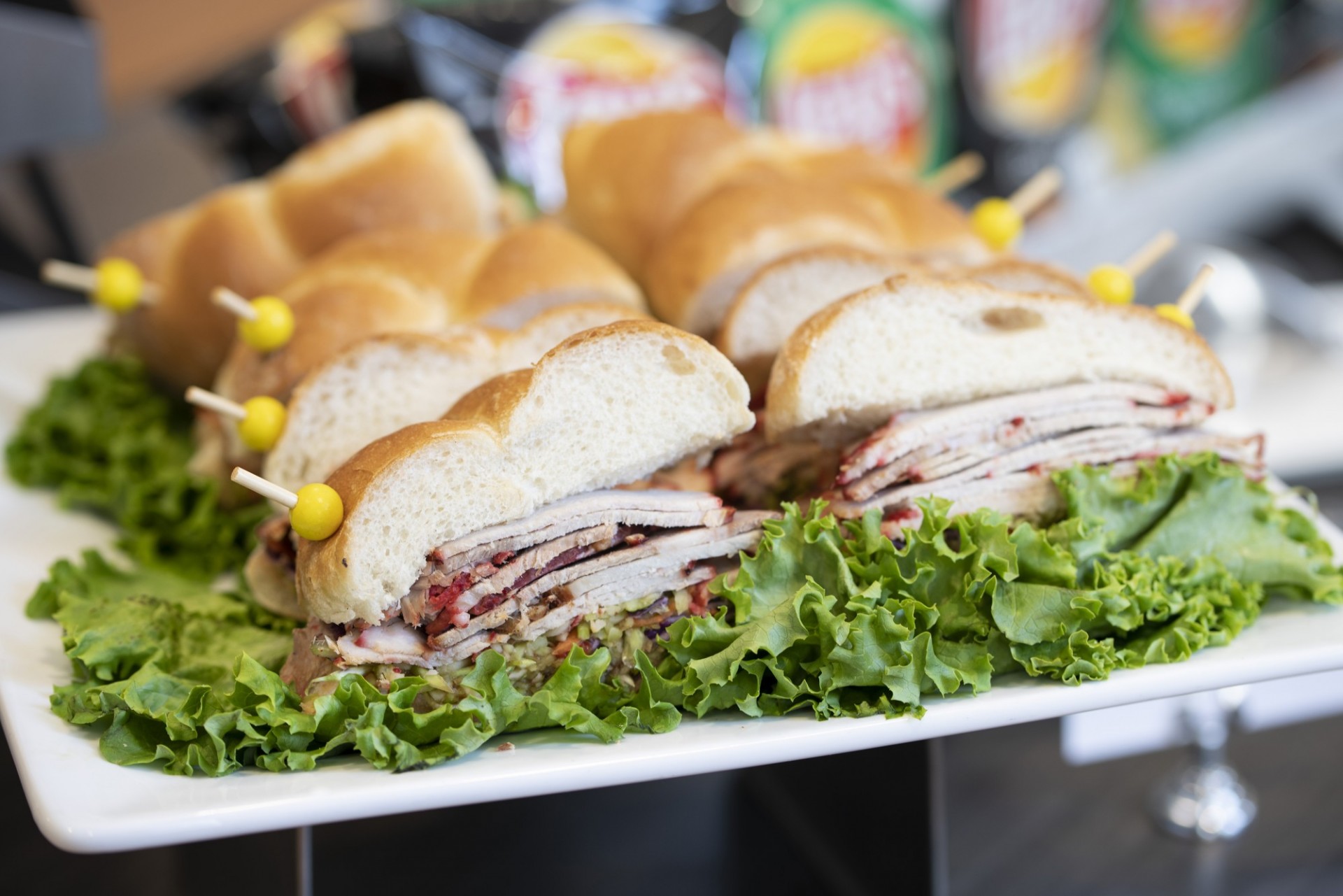 Roast pork sandwiches sit on a bed of lettuce