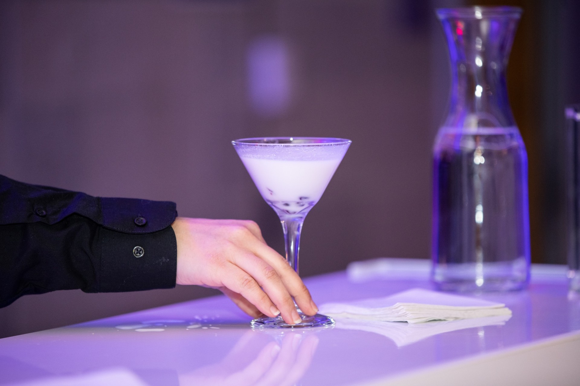 A person serves a cocktail