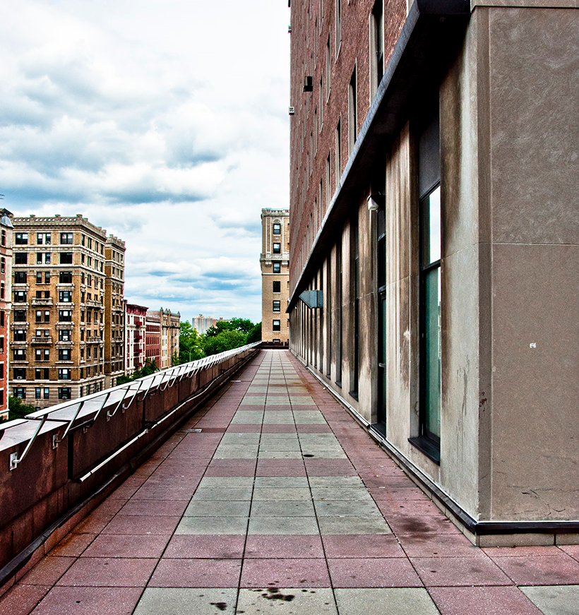 Alternate view of Mudd Terrace: a red and concrete pathway adjacent to a building.