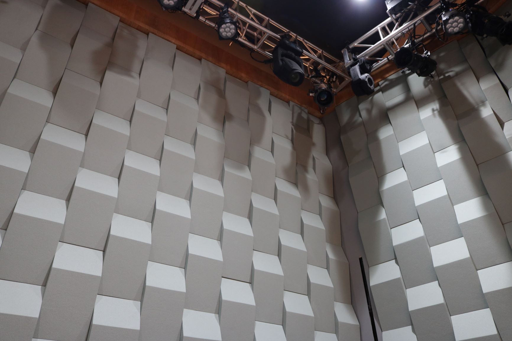 The entire space features acoustic treatment, like this acoustic wedge wall on the stage