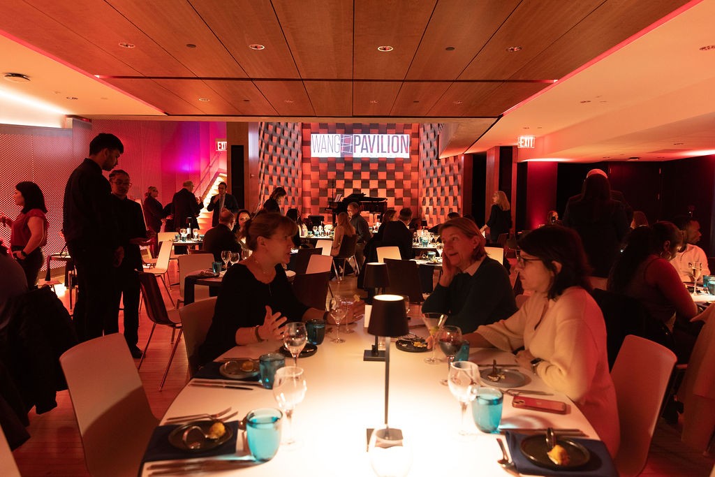 Room full of guests enjoying dinner