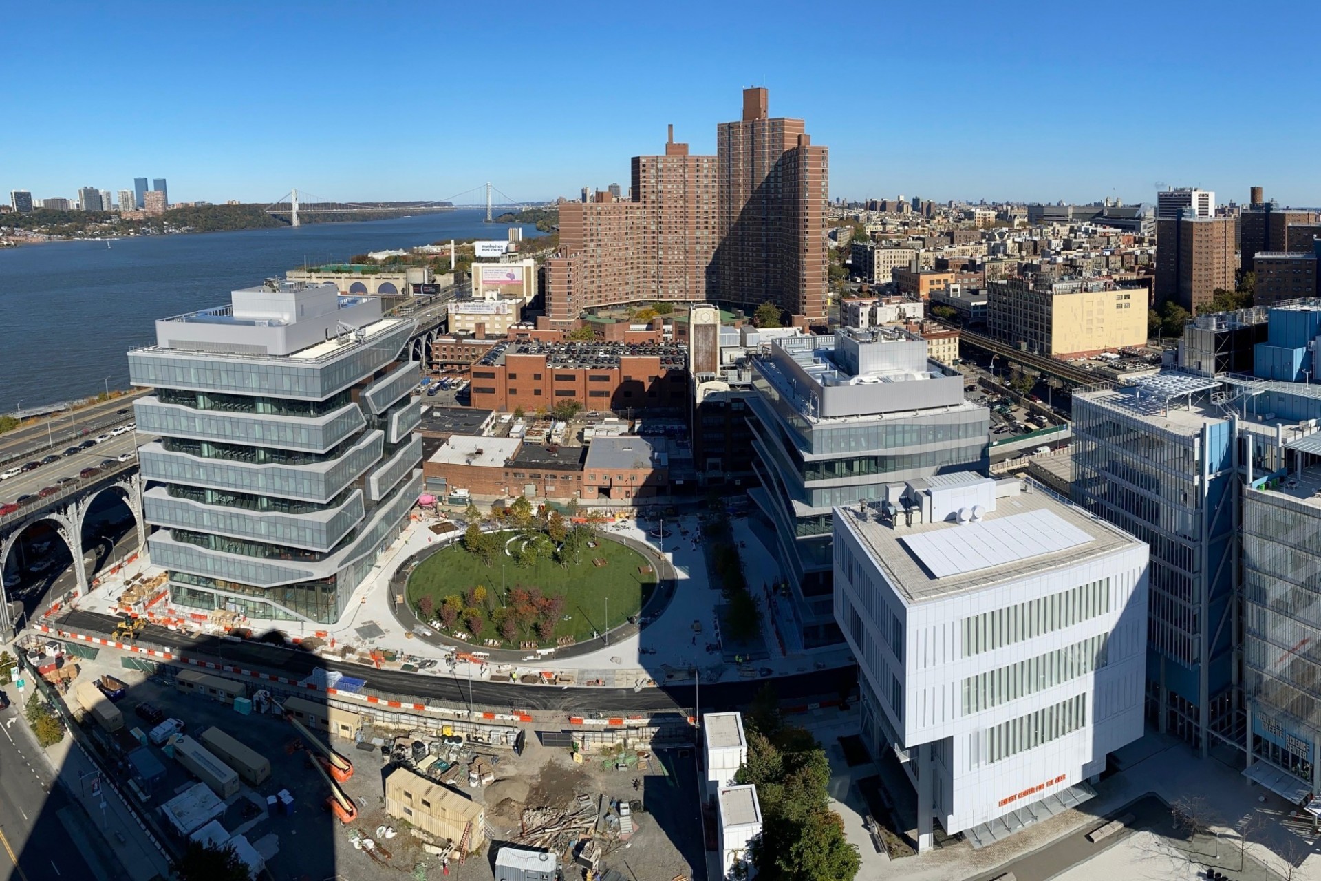 An aerial shot of the Manhattanville campus with a fish-eye lens, showing the Lenfest Center for the Arts, the Square, and the Business School.