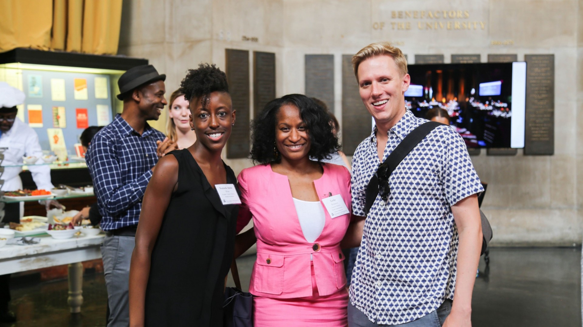 Attendees at a reception pose for a photo