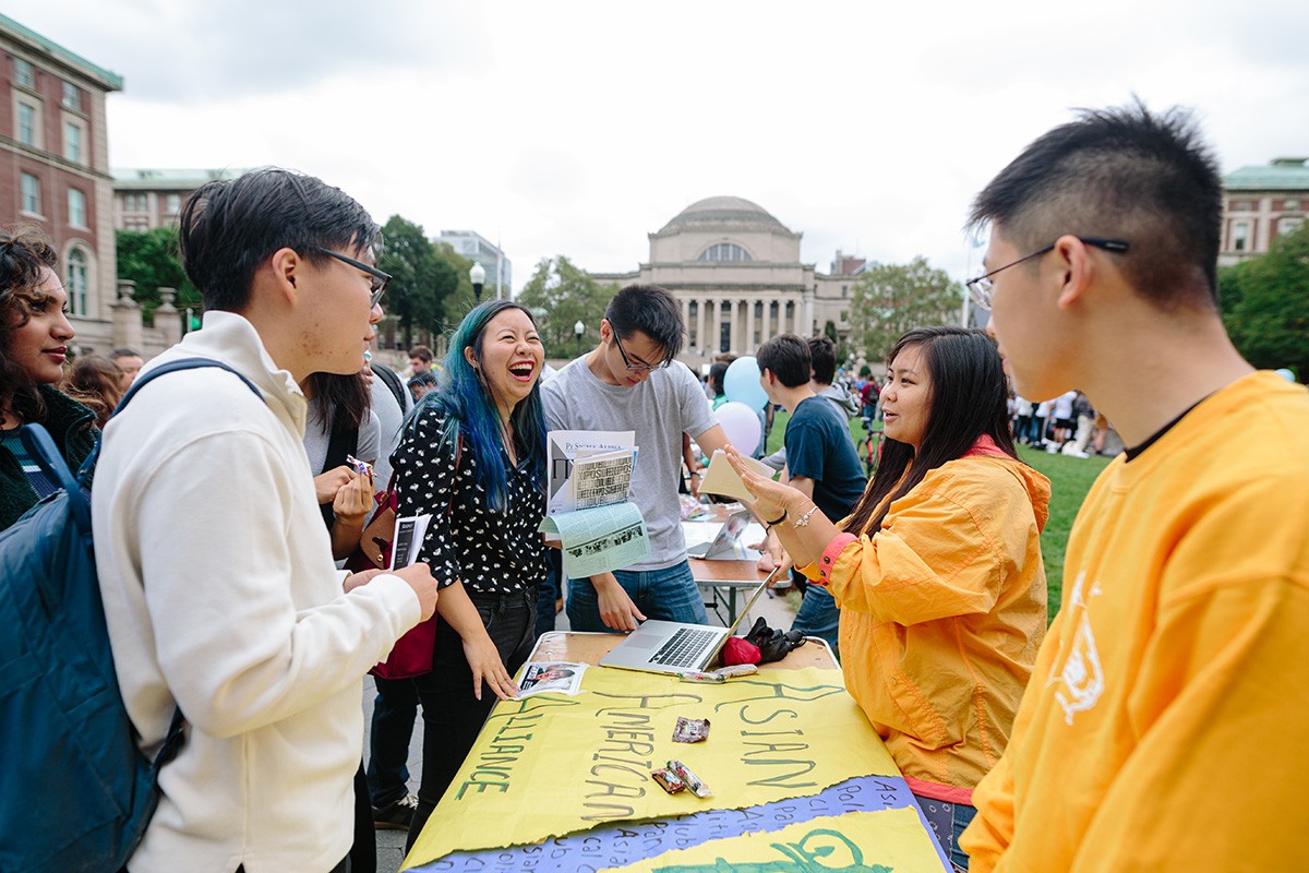 Students table during an activity on campus