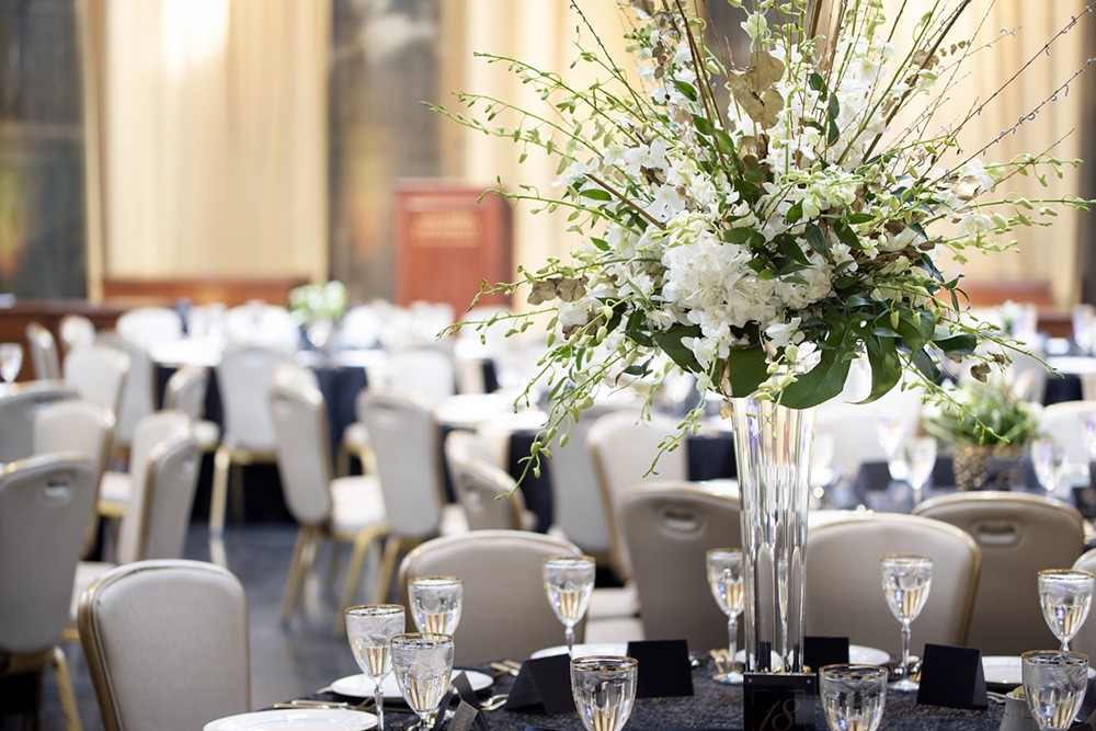 Beautiful flowers adorn tables set with white linens.