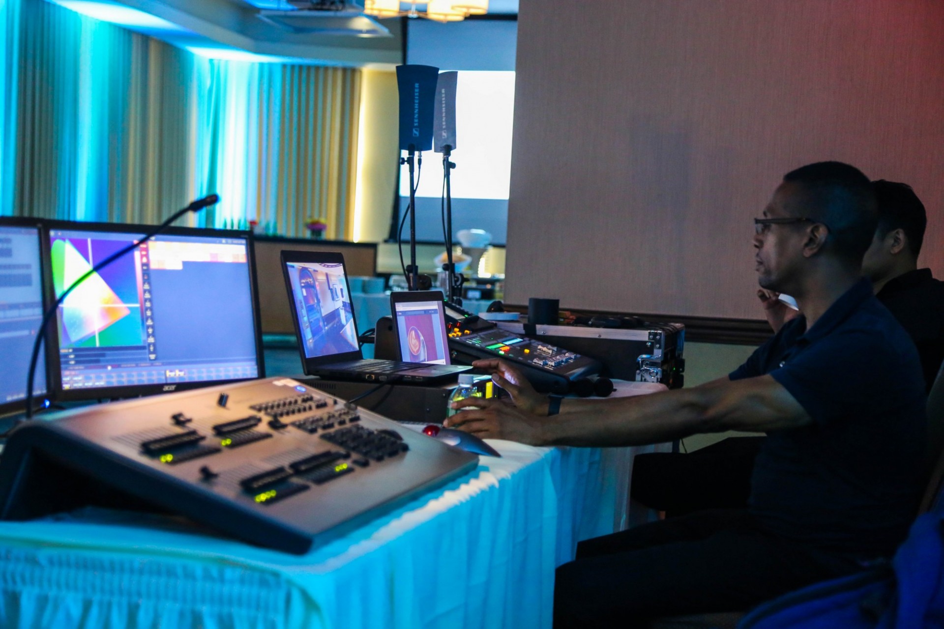 AV team at a soundboard in the control room