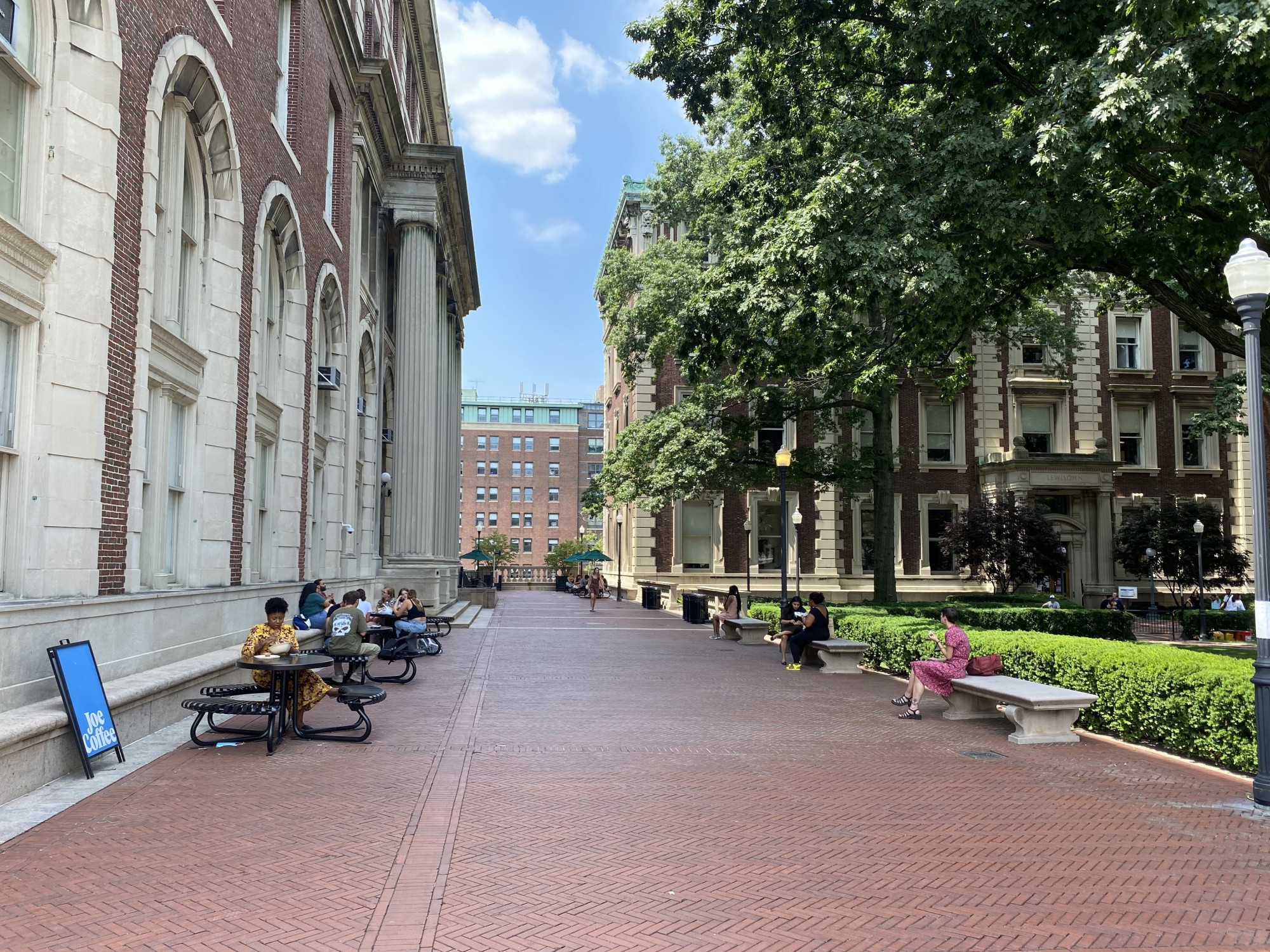 An open air tent erected on a brick walkway between Dodge Hall and the lawn.