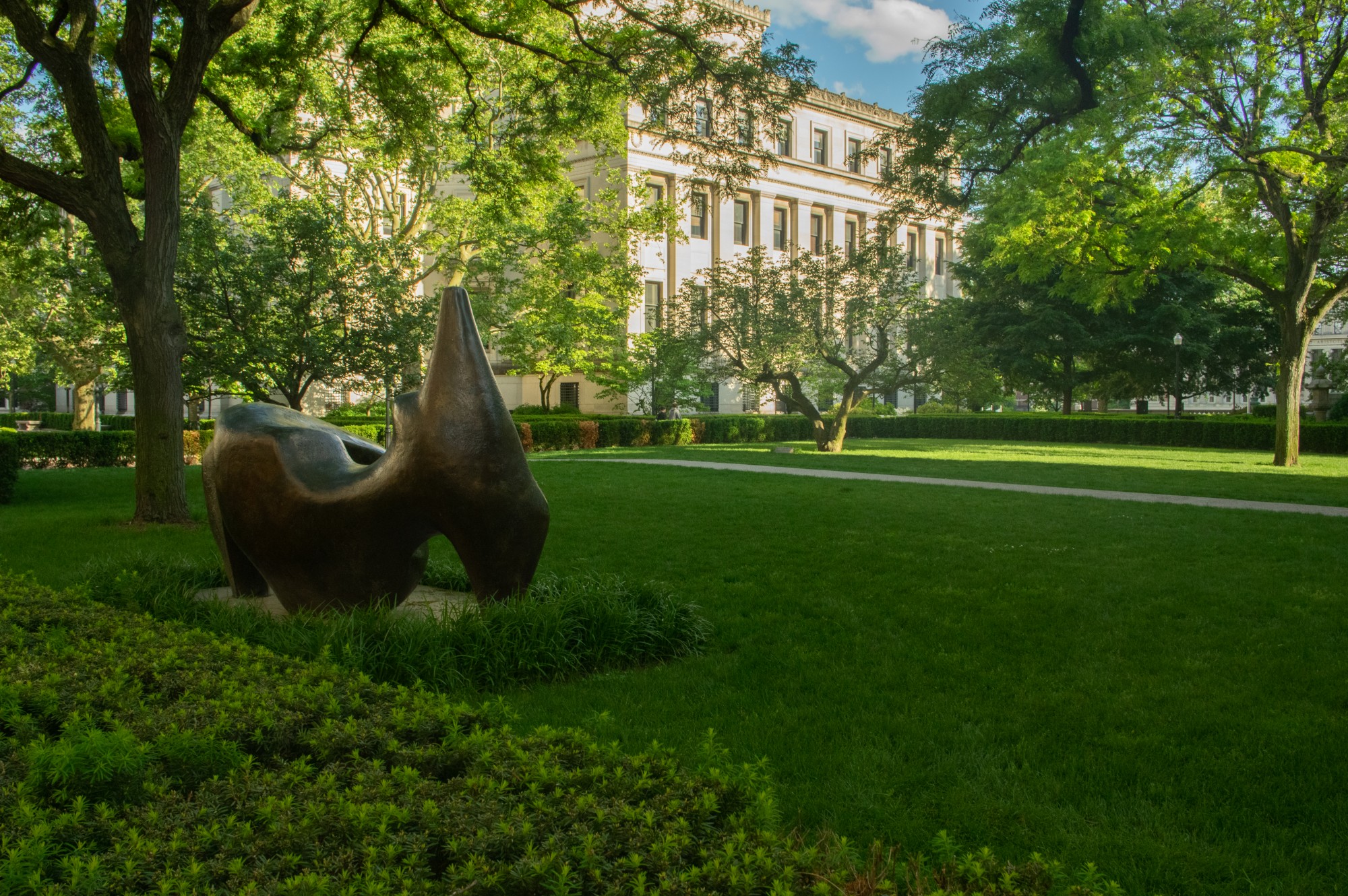 Mathematics Lawn North on a sunny afternoon, a Henry Moore statue in the foreground.