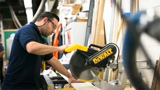 Facilities employee working in a wood shop.