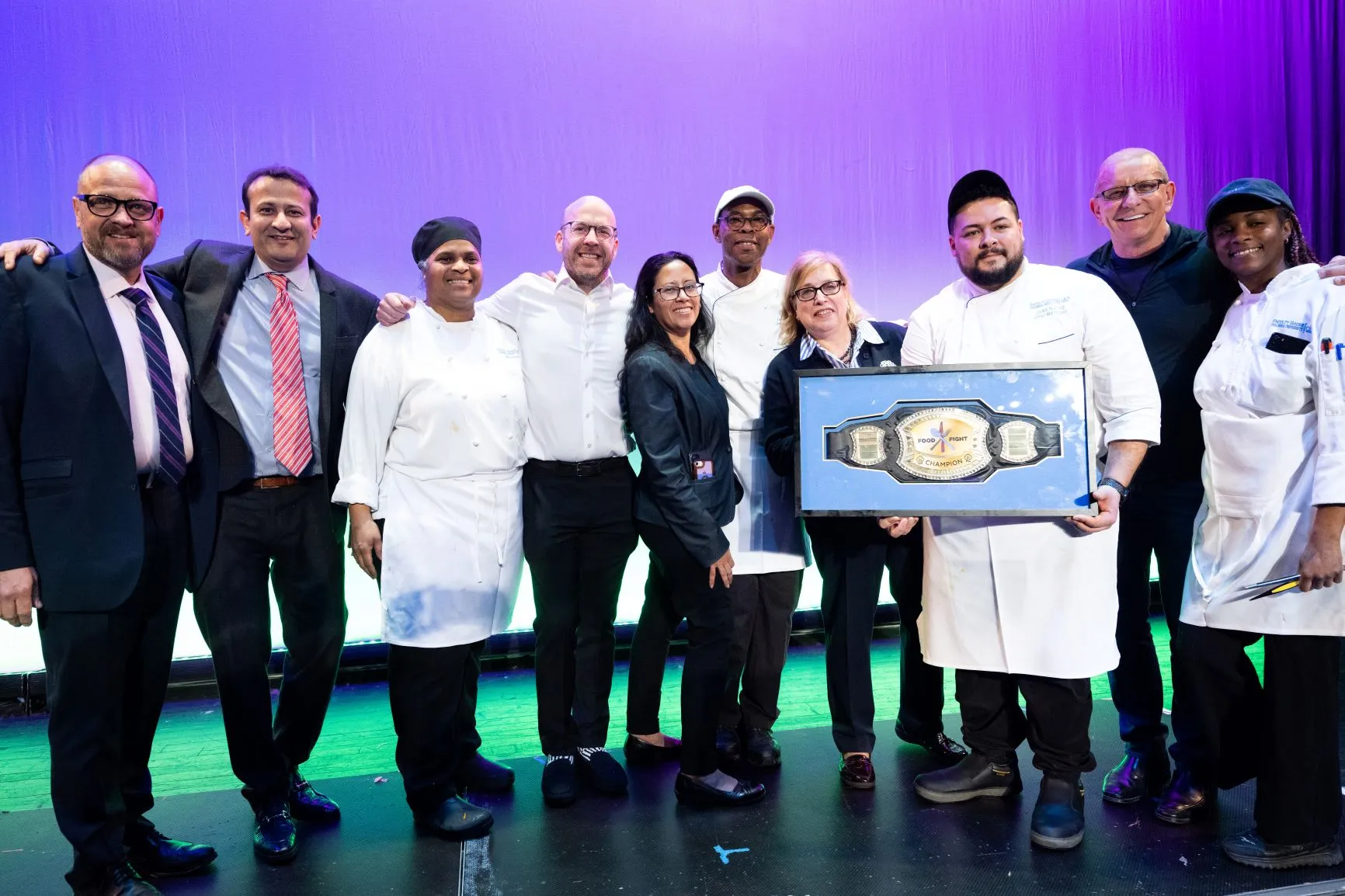 The Faculty House team proudly displays the winner's belt