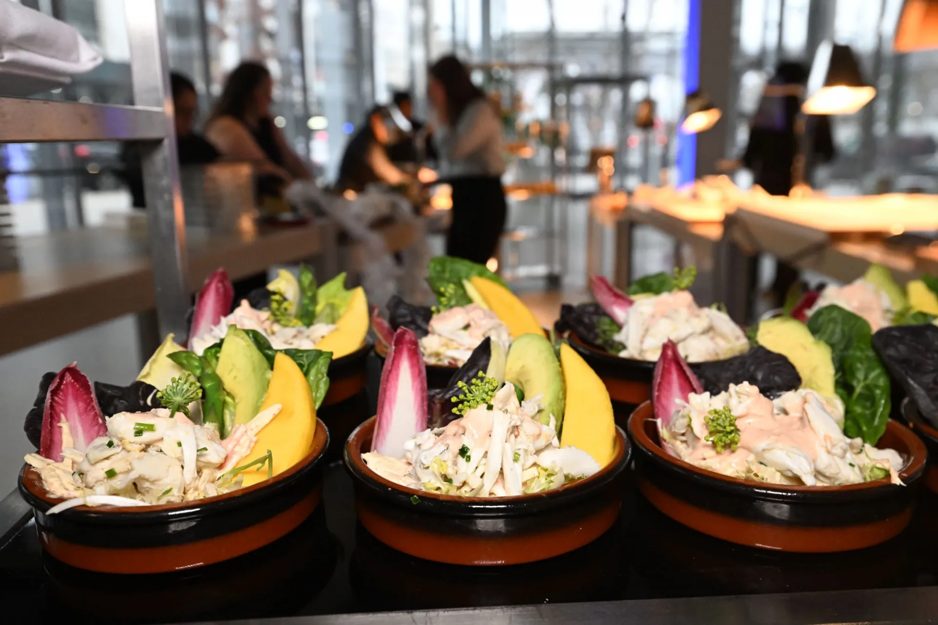 Crab Salad featuring heart of palm, avocado, gem lettuce, endive, frisée, asparagus, radish and topped with creamy cocktail sauce