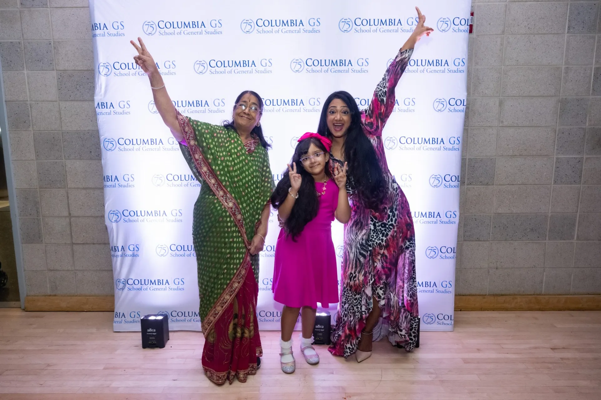 Guests pose in front of the step-and-repeat