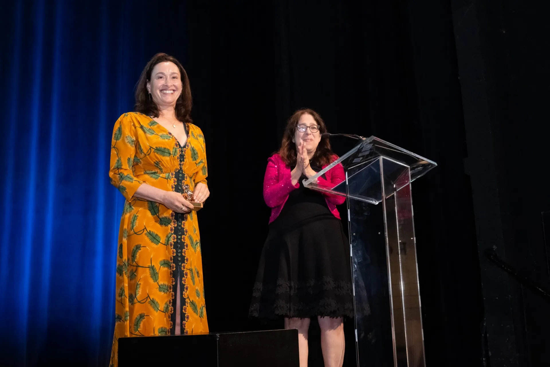 Allison Fillmore ‘97GS and Dean Rosen-Metsch stand together on stage