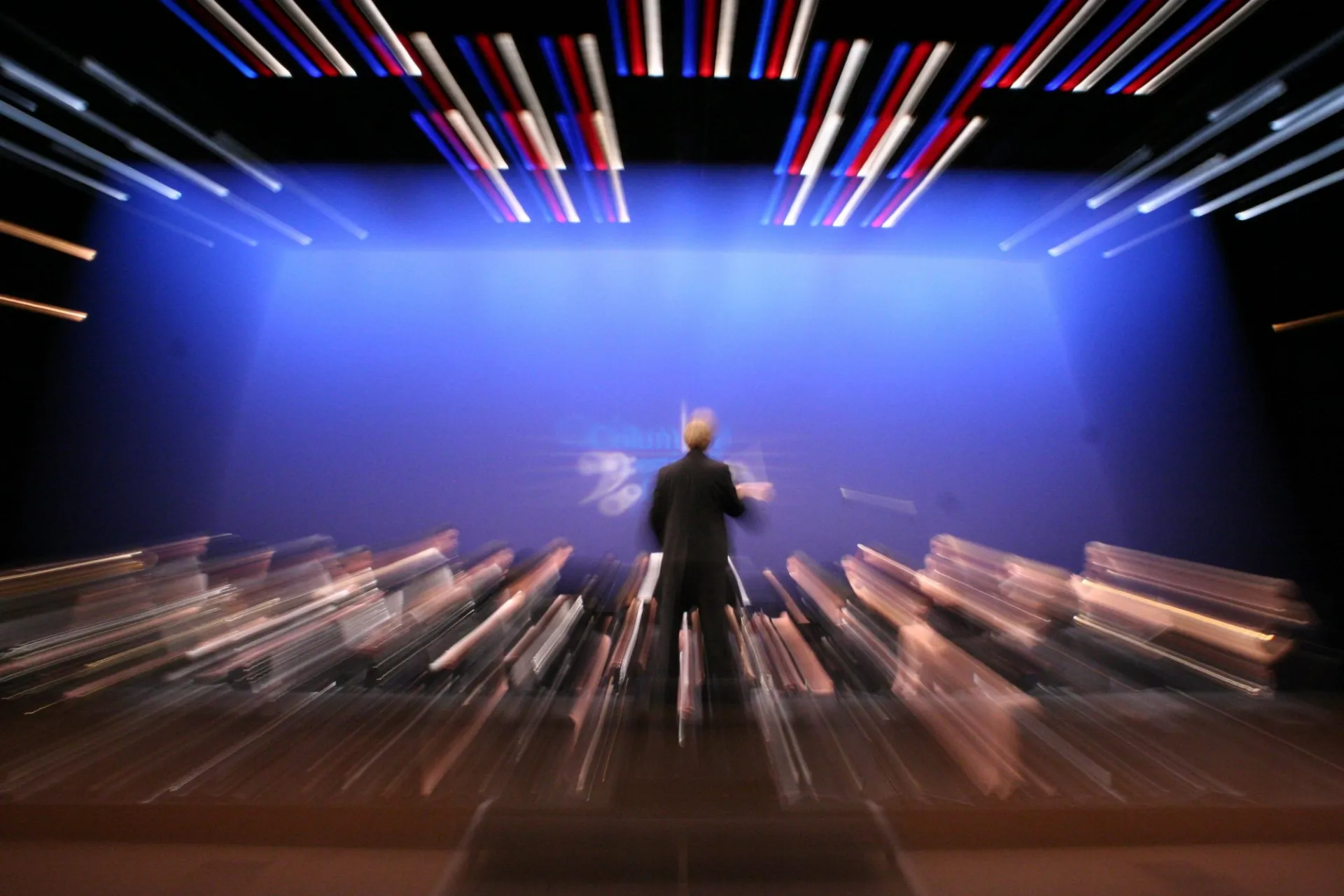 Conductor on stage during dramatic performance