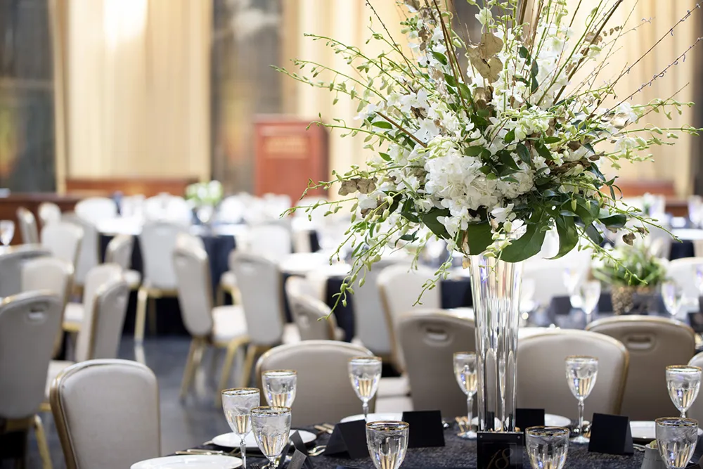 Beautiful flowers adorn tables set with white linens.