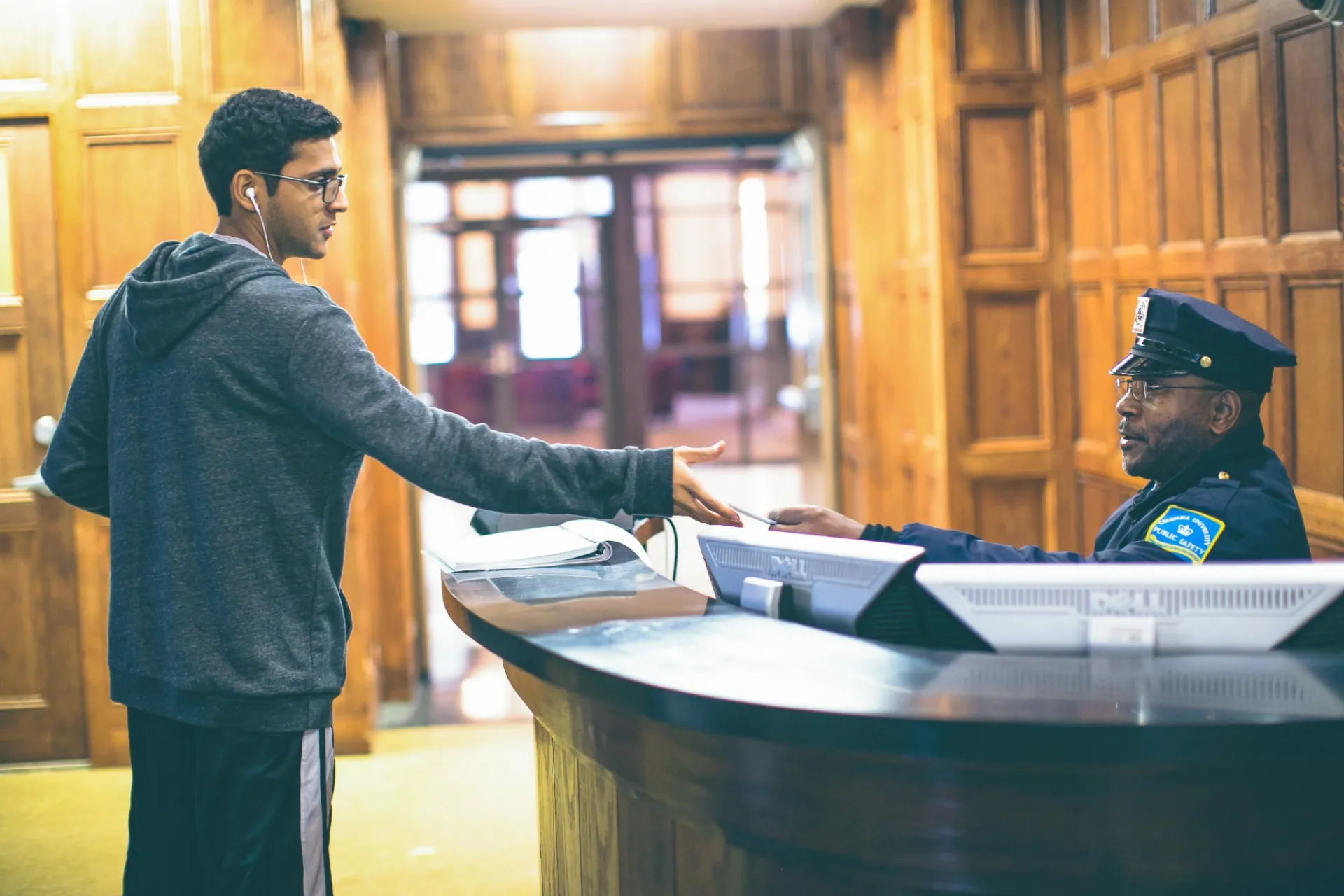 A student showing an ID to a security guard